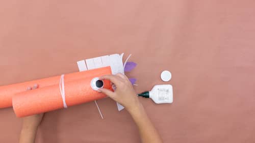 gluing googly eyes onto pool noodle horse 