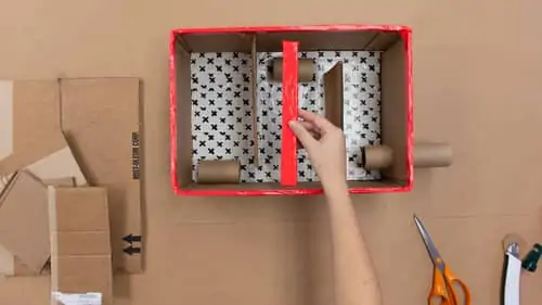 cut narrow piece of cardboard and cover with orange tape