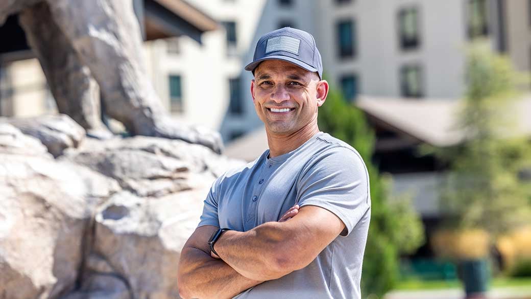 man wearing a blue shirt in front of a Great Wolf lodge