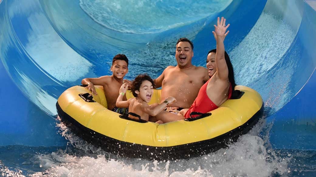 Family sliding down a water slider