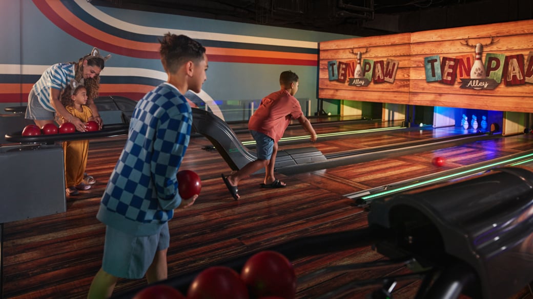 Boy smiling while playing bowling