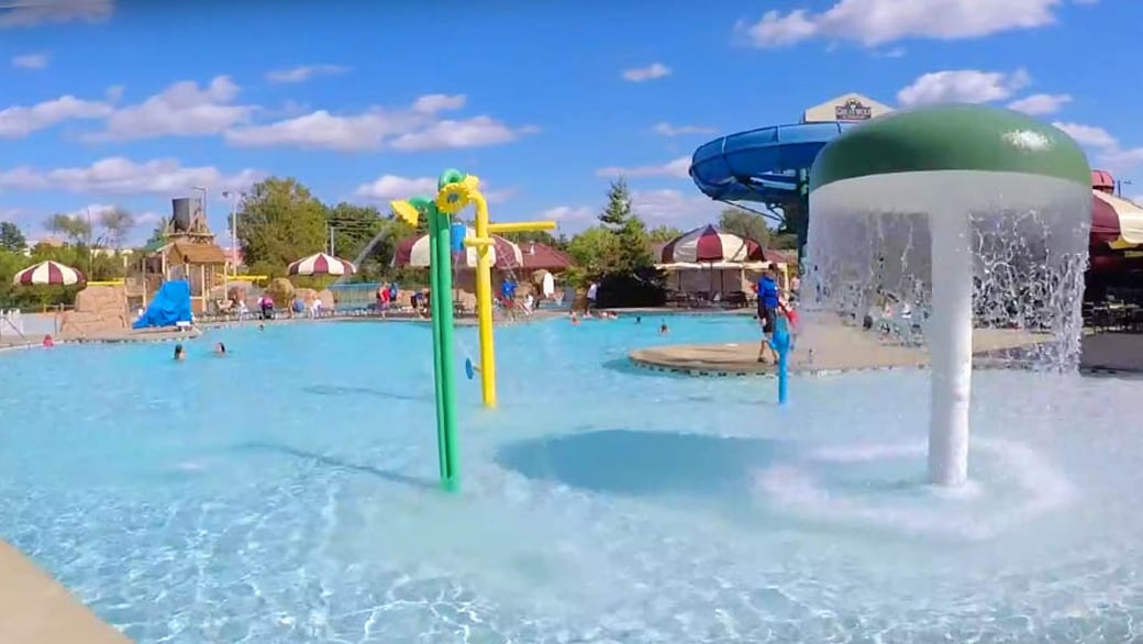 Kids play behind the outdoor water features 