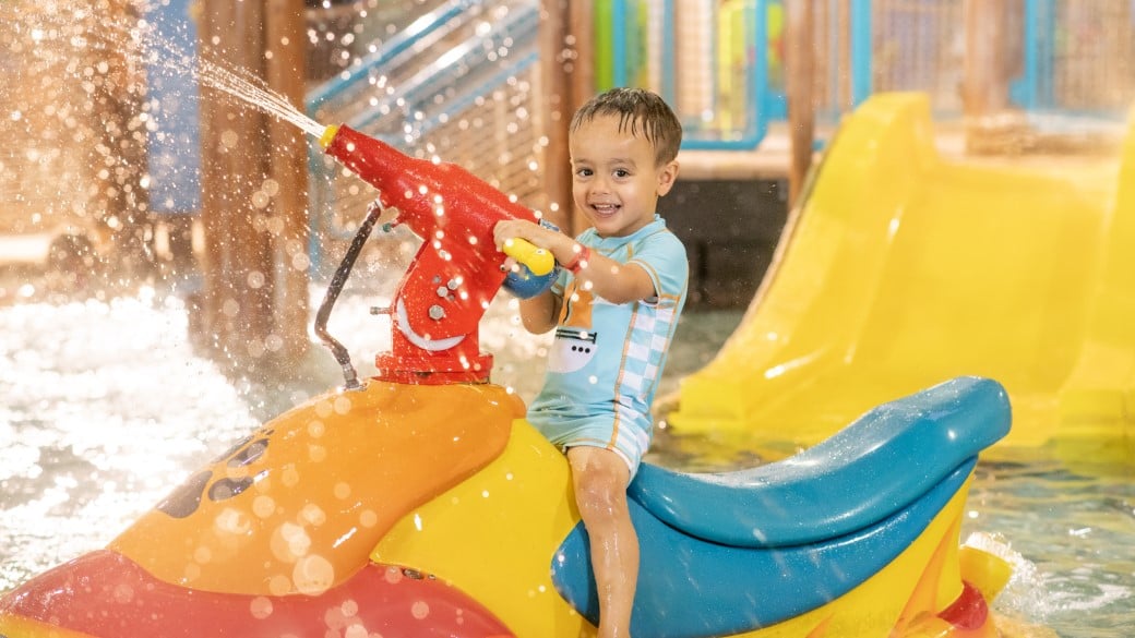 Little girl enjoying cub paw pool