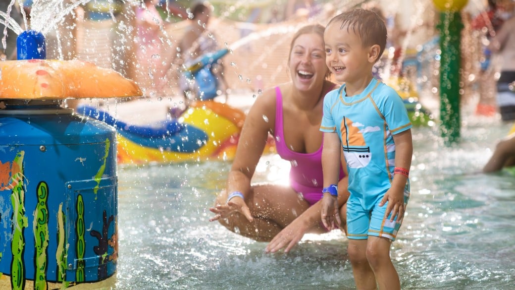 mother and child enjoying in a kidee pool in waterpark