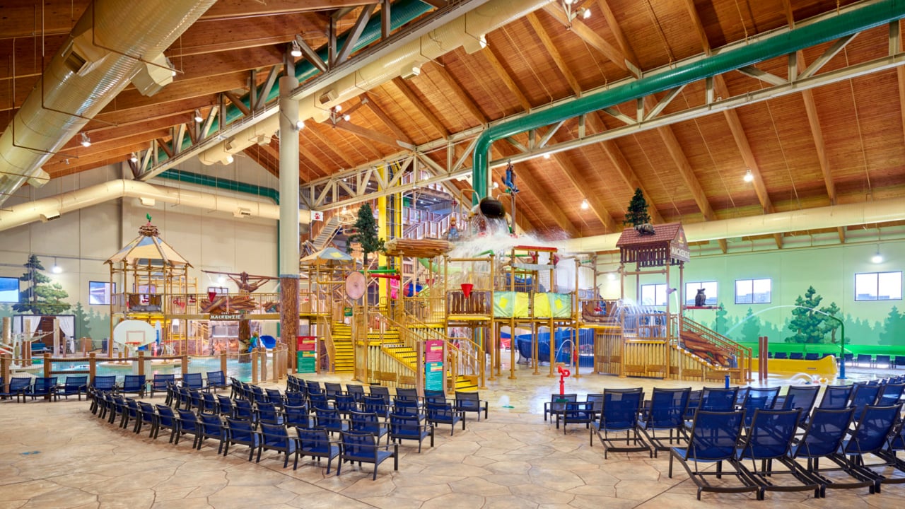 A wide shot of the  water treehouse as water splashes down from a bucket above the jungle gym