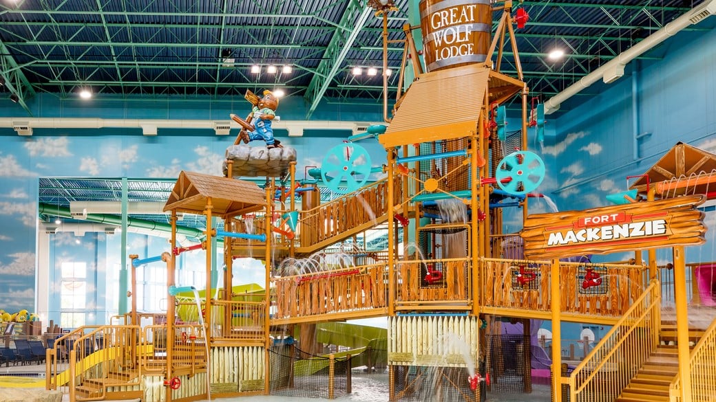 A wide shot of the  water treehouse as water splashes down from a bucket above the jungle gym