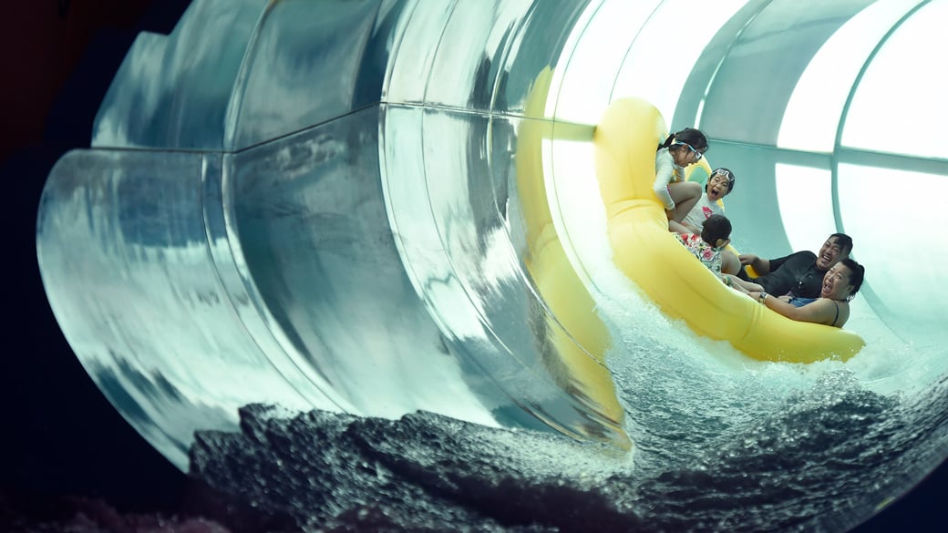 Family of five rides down enclosed waterslide 