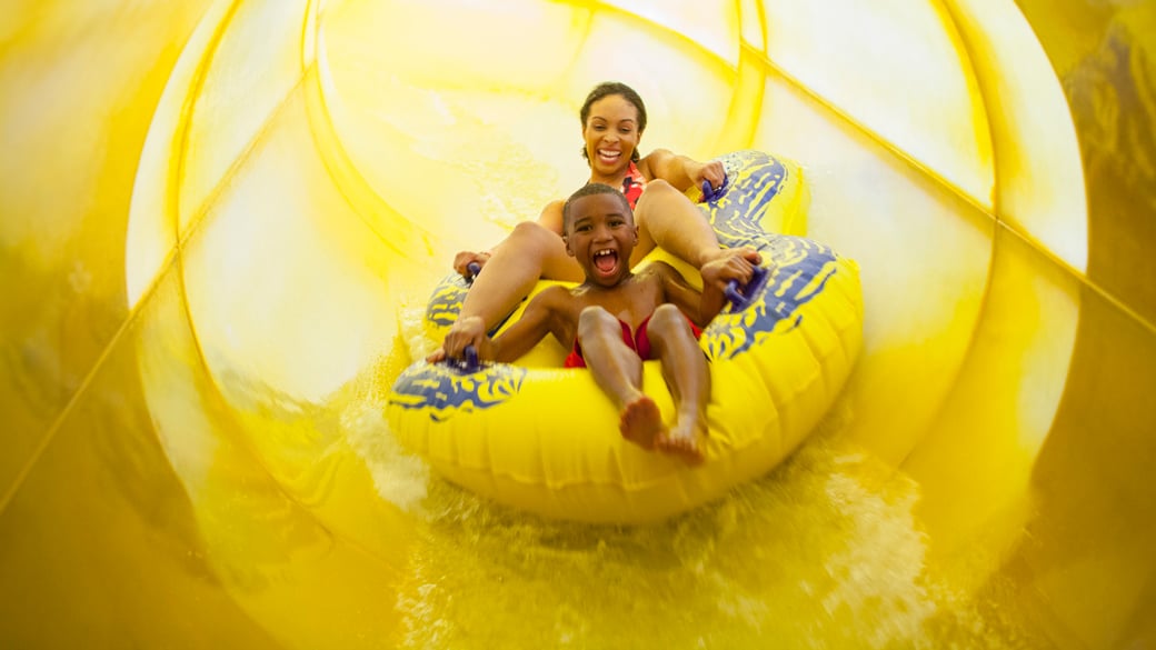 mother and kid riding a tube in alberta falls