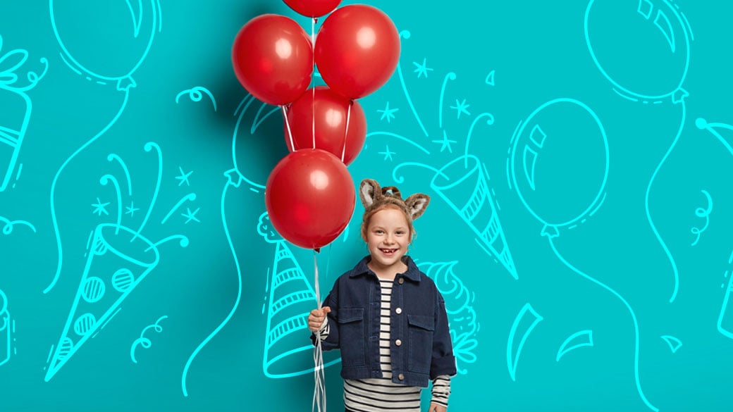 girl holding red balloons and celebrating her birthday 