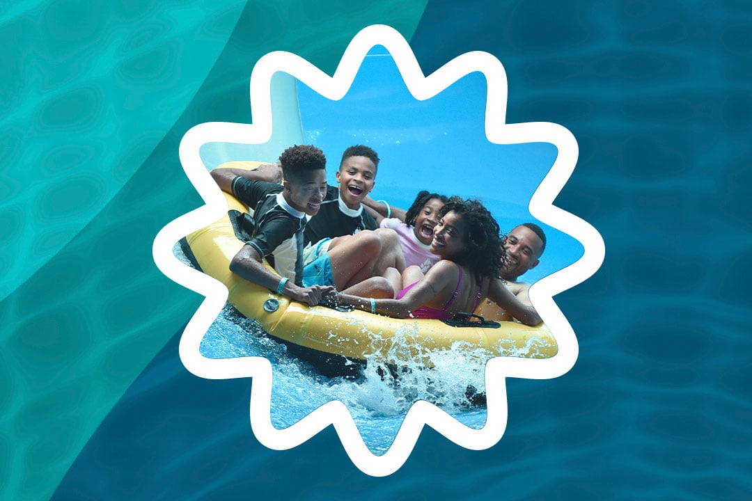 family sliding down a water slider in a yellow floats