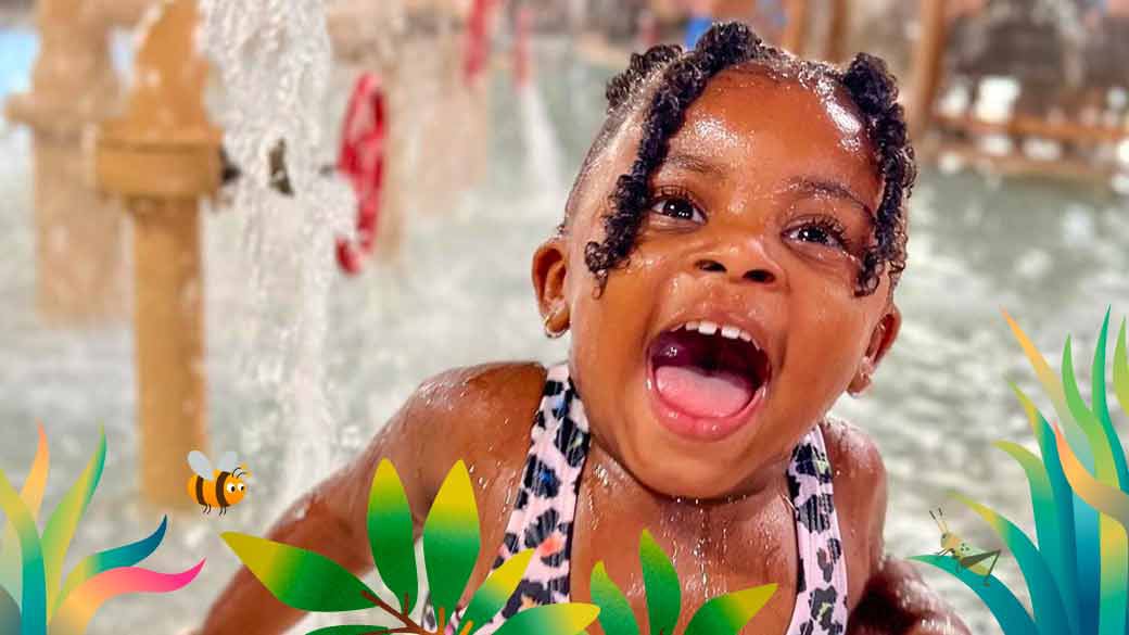 Little girl swimming in an indoor pool at Great Wolf Lodge