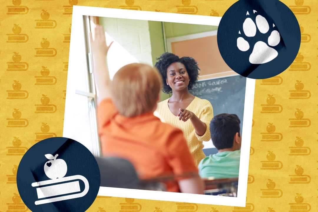 Teacher pointing at a student who raised their hand in classroom