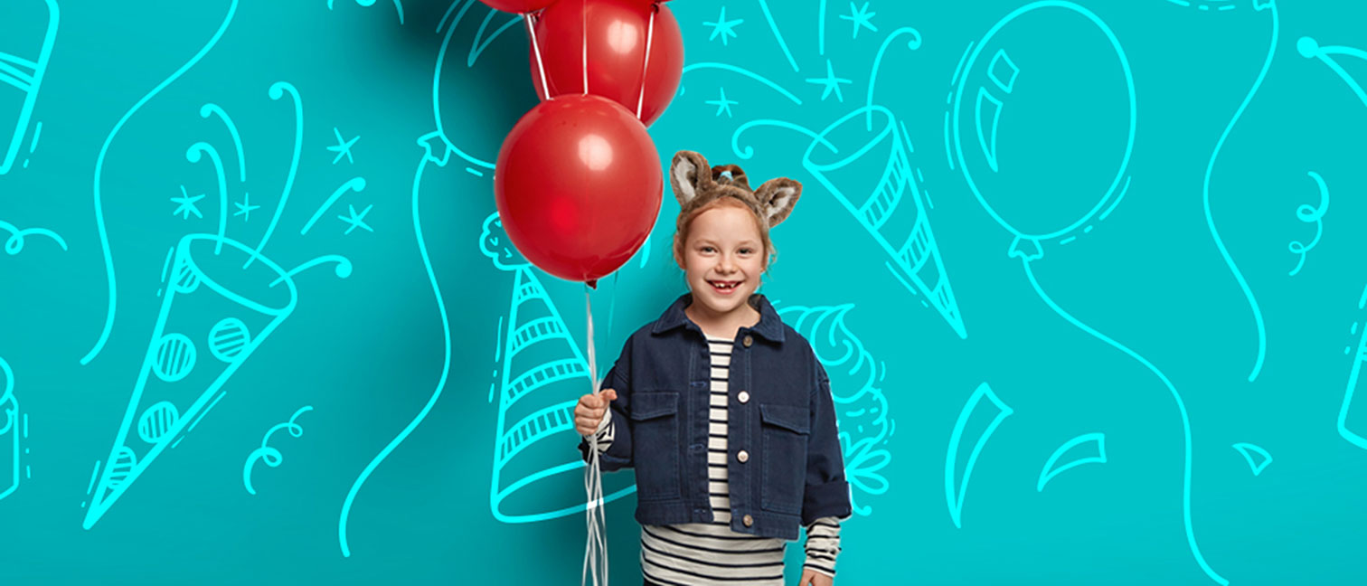 girl holding red balloons and celebrating her birthday 