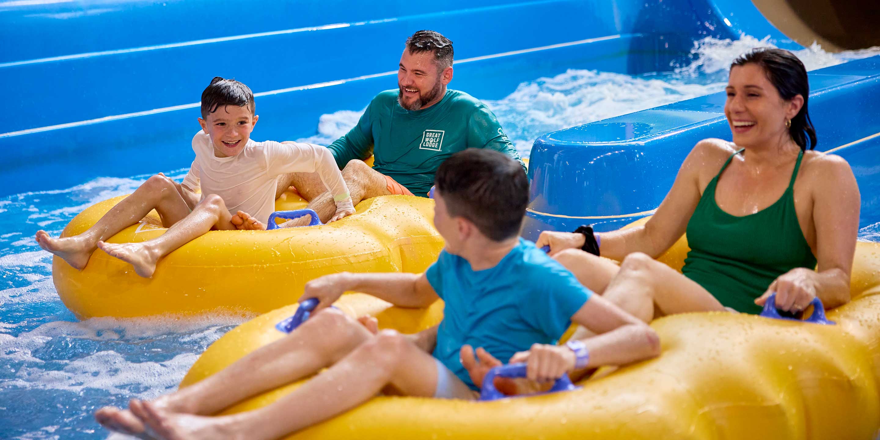 family enjoying sliding down a tube on a waterslide