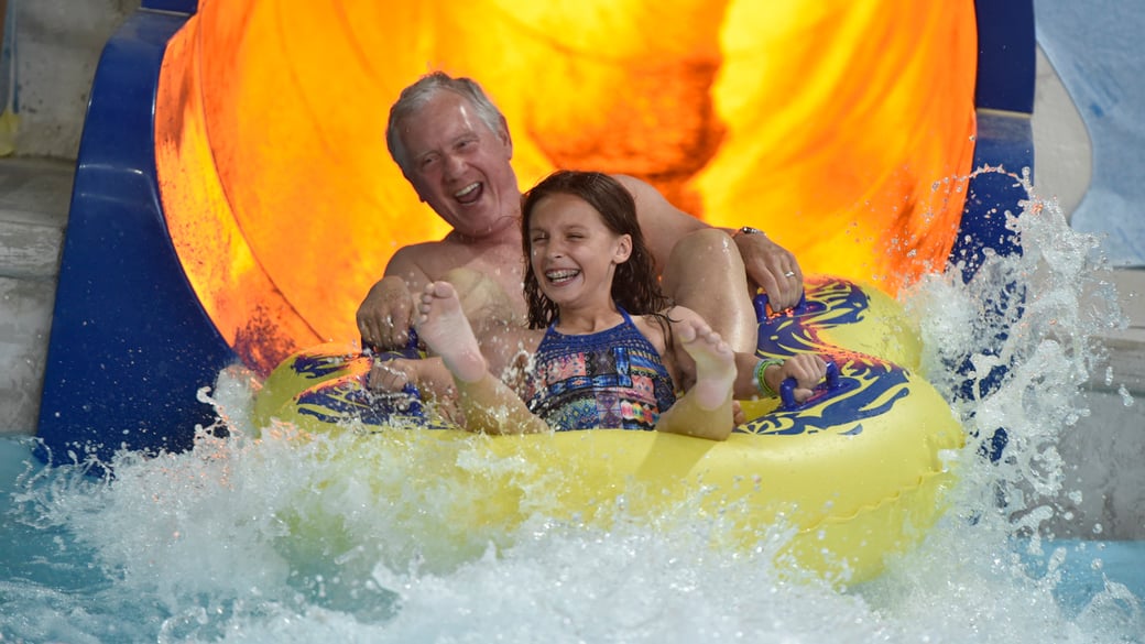 Grandparents and Grand-daughters slide down the water slide 