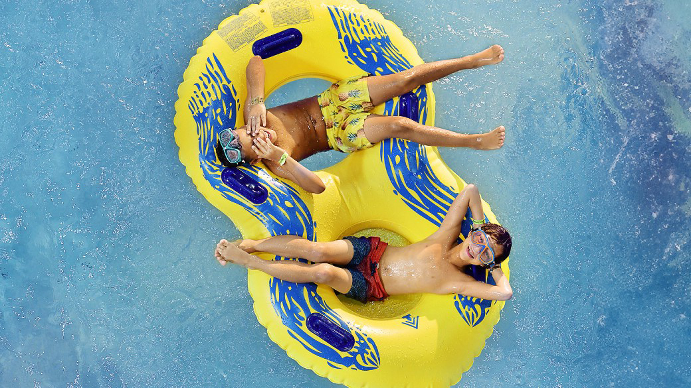 youngs boy floating on a yellow float at Great Wolf Lodge