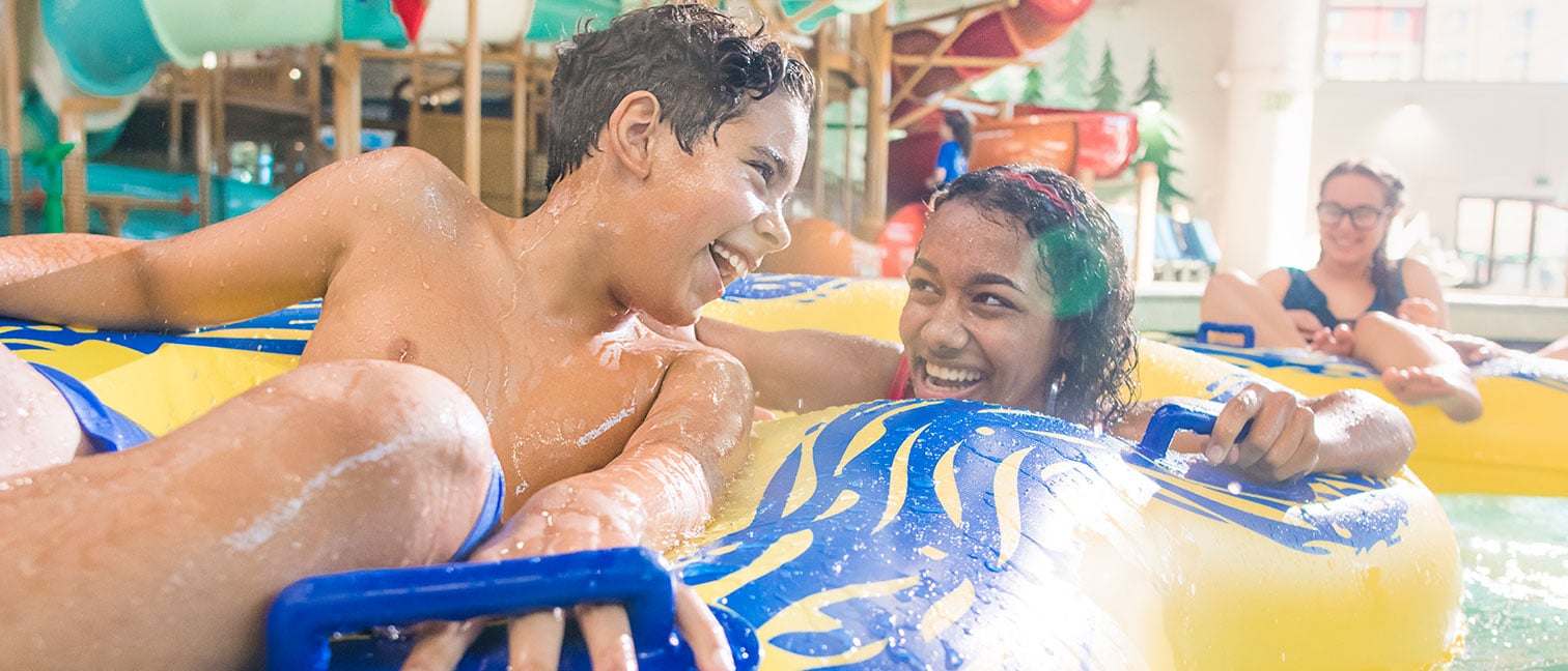 teens on a yellow tube going down a lazy river