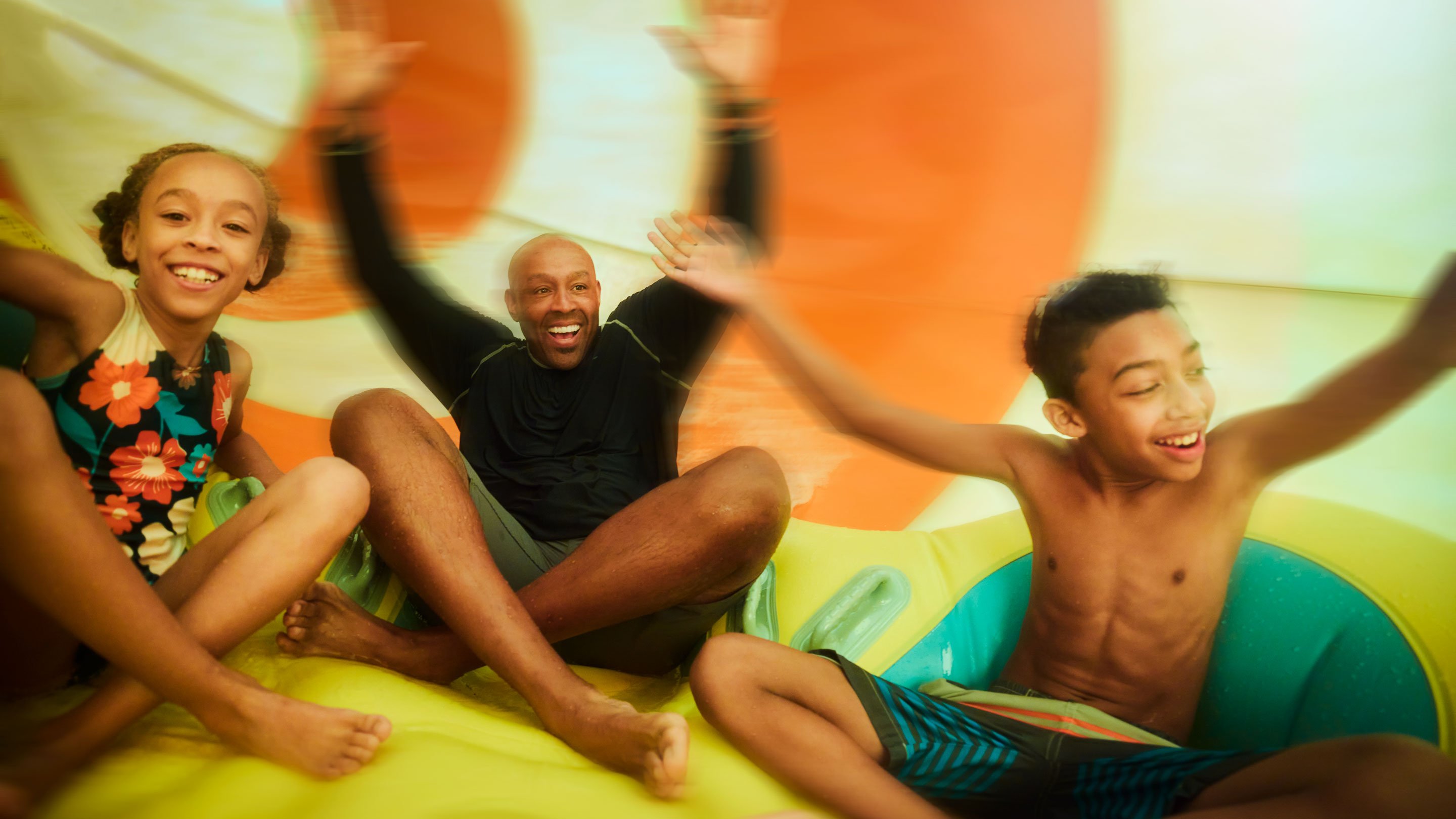 A family having fun together on a waterslide