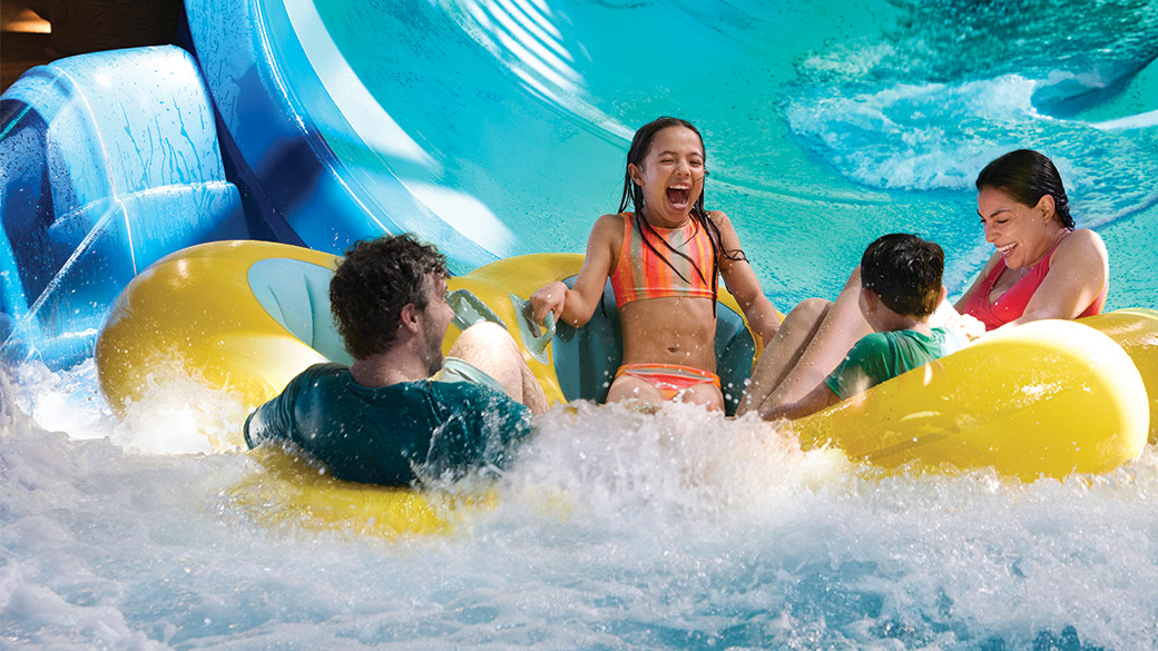 Family enjoying indoor water slide at Great Wolf Lodge