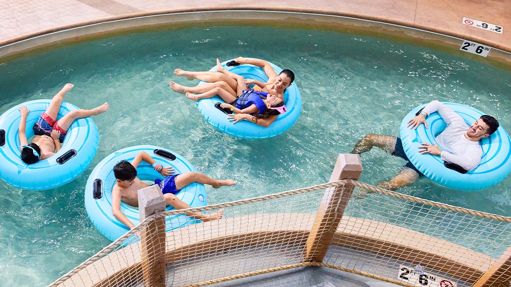 Family & kids enjoying indoor lazy river at Great Wolf Lodge