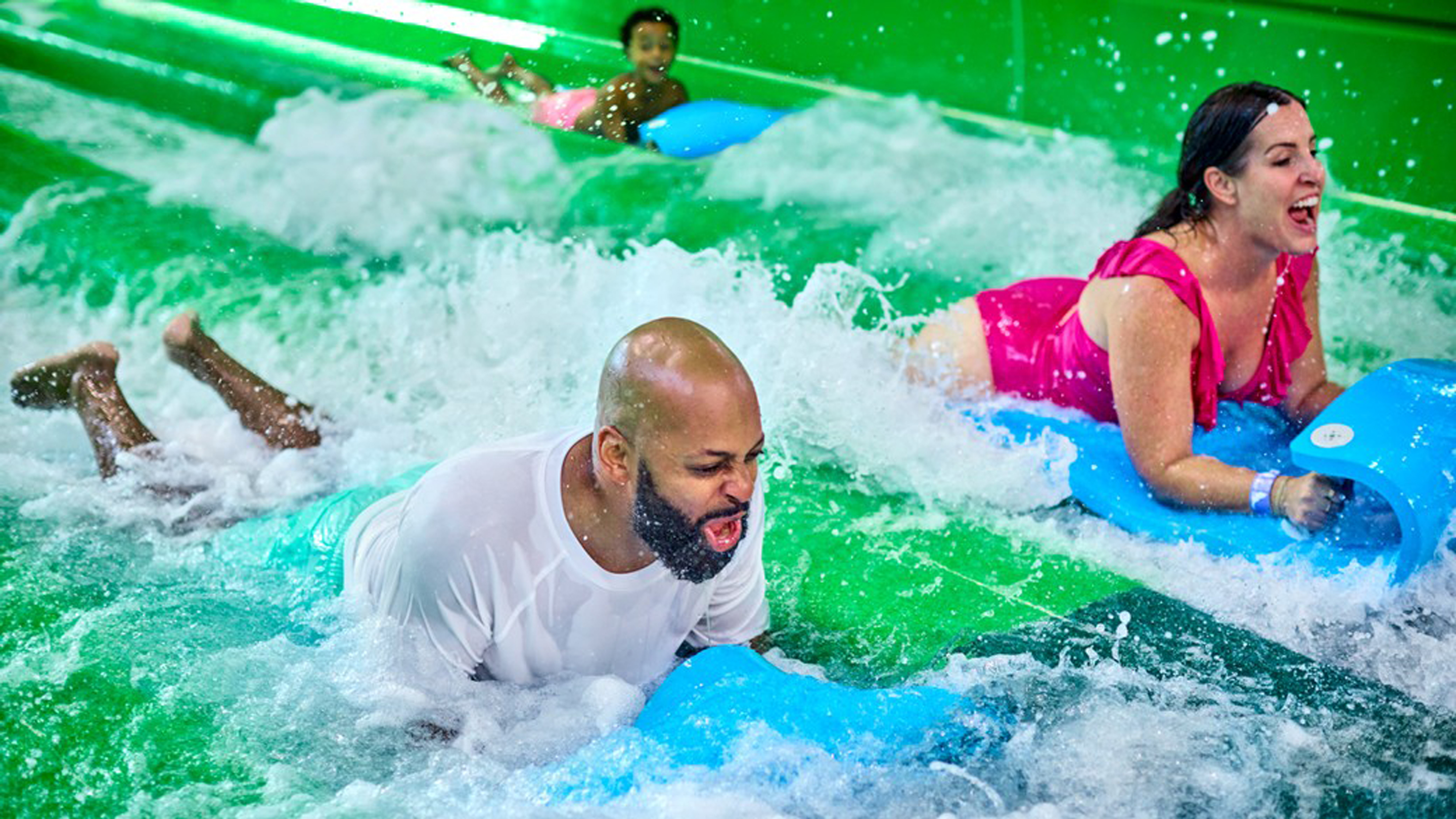 Parents sliding down a water slide at Great Wolf Lodge