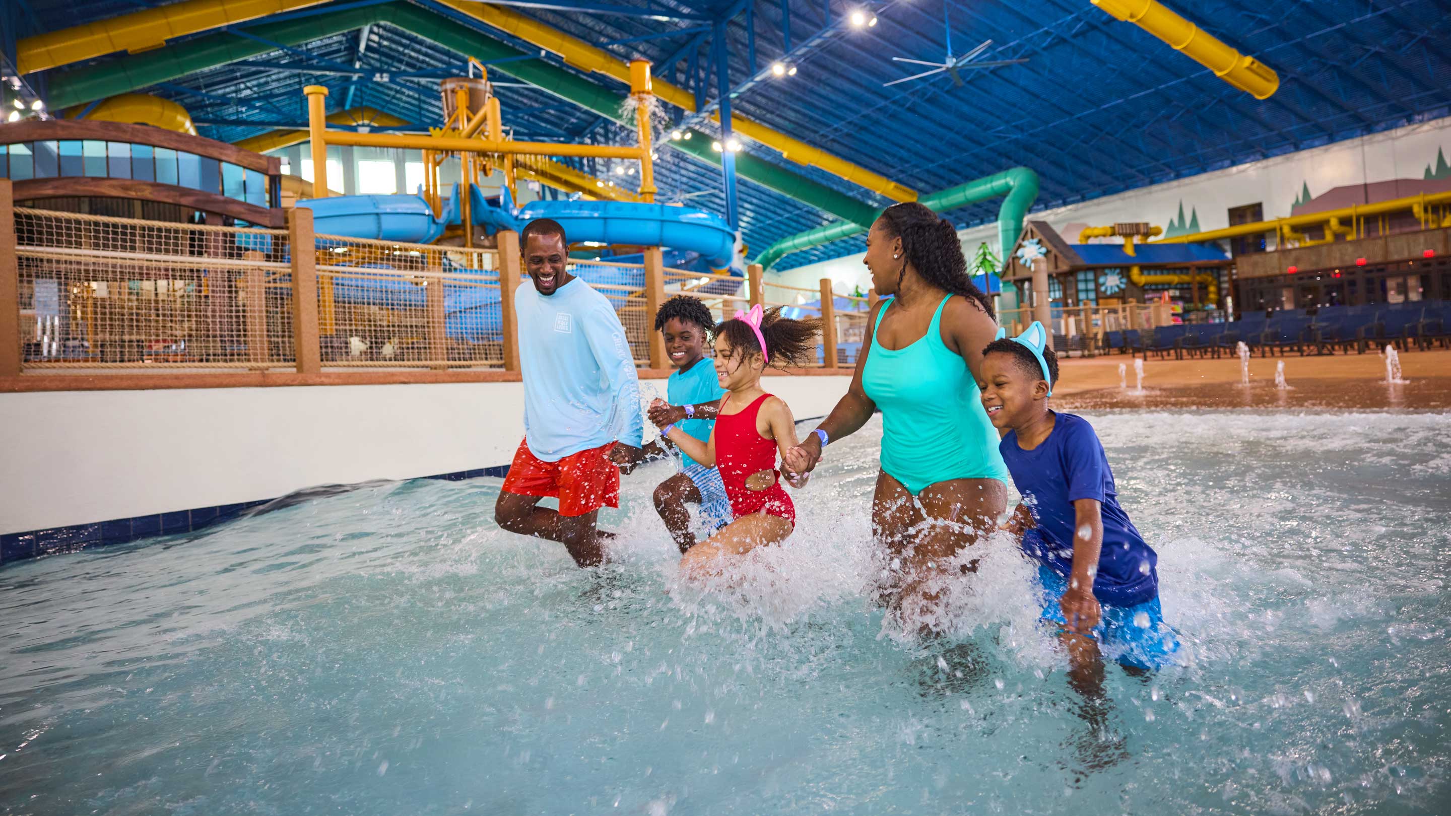 family enjoying splashing and running in a wave pool