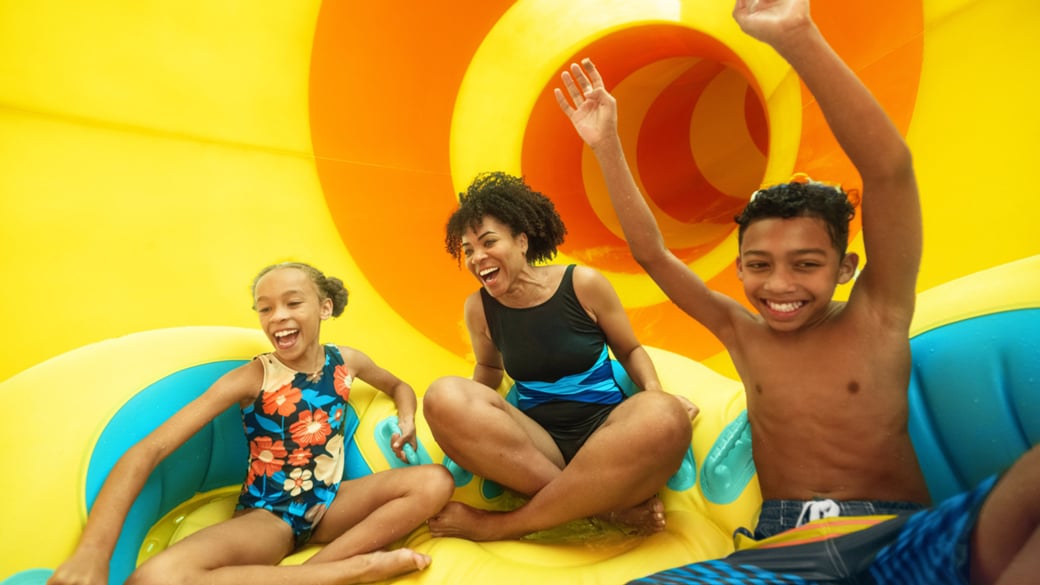 family of 3 enjoying the water ride on a tube