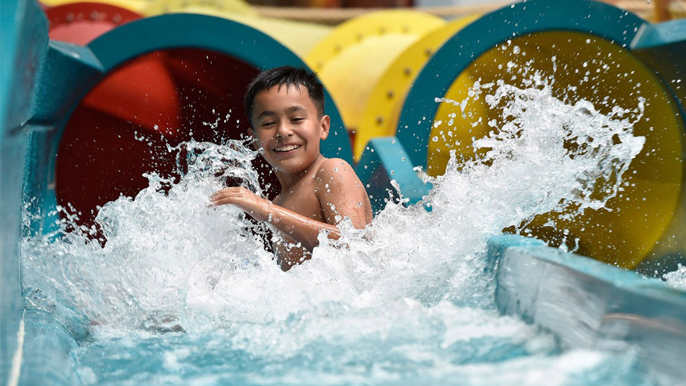 Boy having fun on a water slide