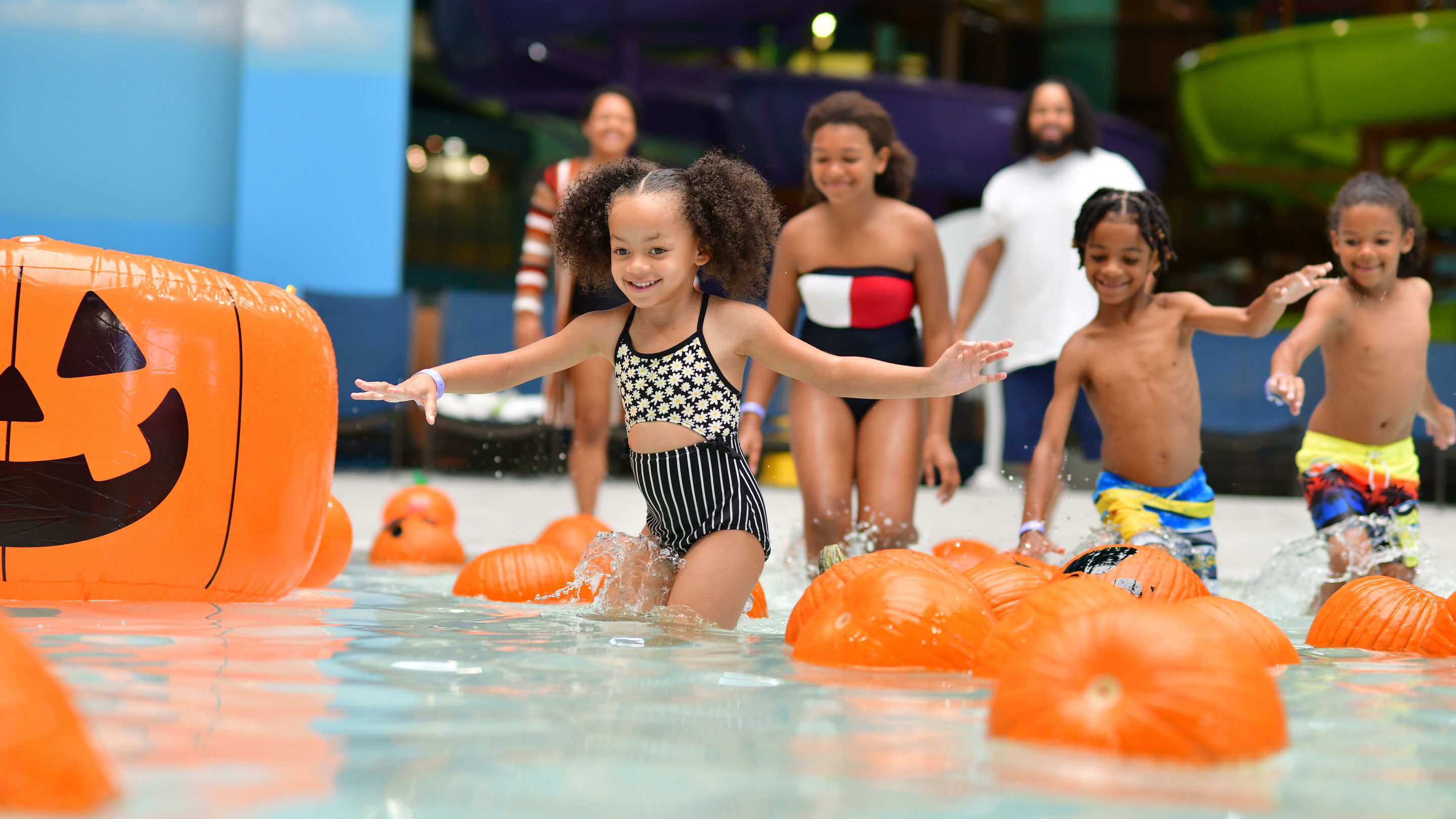 Kids enjoying spooky fun in a pool