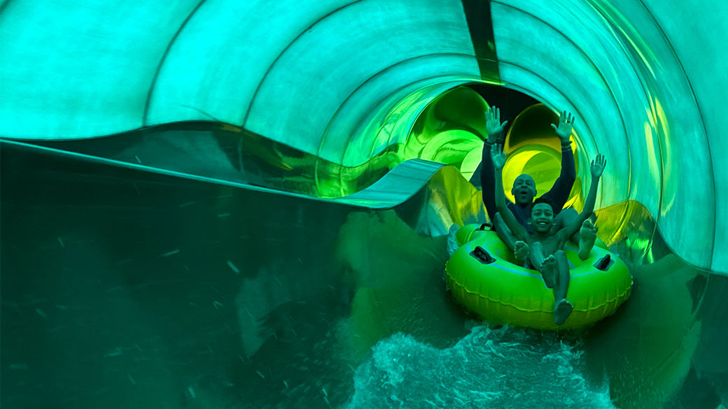 Father and son sliding down a water slide at Great Wolf Lodge