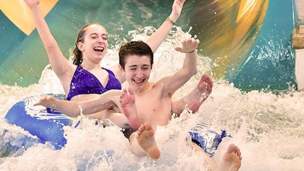 Guests enjoying a water slide in the water park