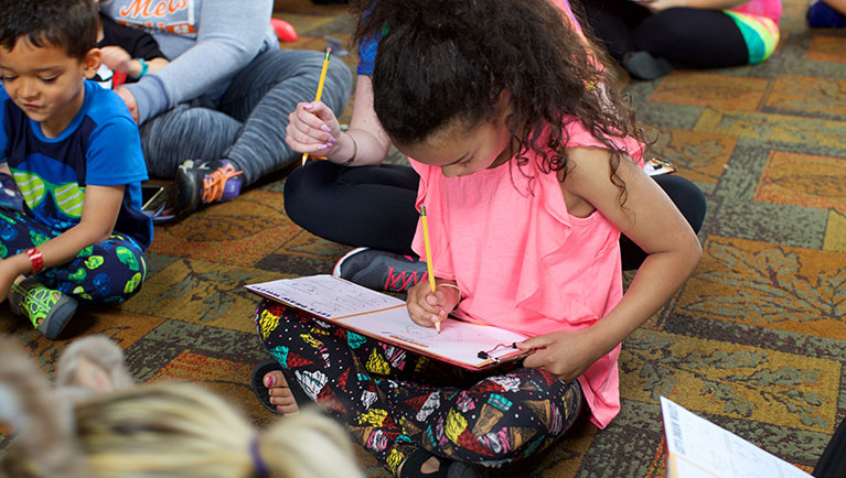 Kids sitting down and drawing