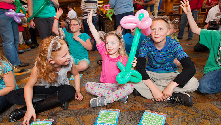 Children sit on the floor playing Bingo