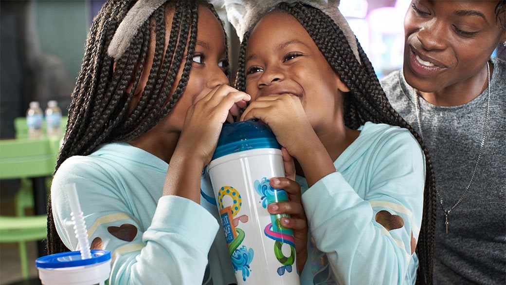 2 children enjoying their soda sipper from the Ultimate Food and Fun deal