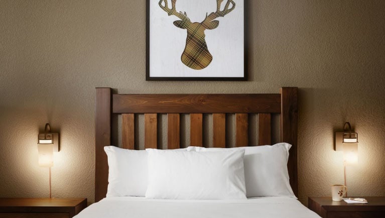 The headboard of the queen bed in the Grand Royal Bear Suite