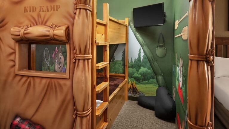 The bunk beds and TV inside the tent in the KidKamp Suite