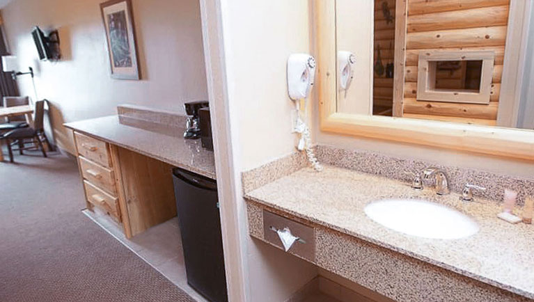 The sink and mini-fridge in the Accessible Bathtub Junior Cabin Suite