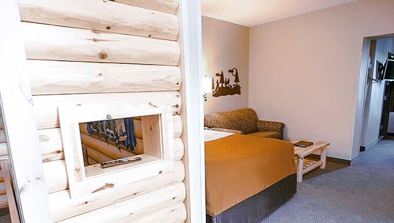 The sofa and queen bed in the Grand Royal KidCabin Suite (Accessible Bathtub)