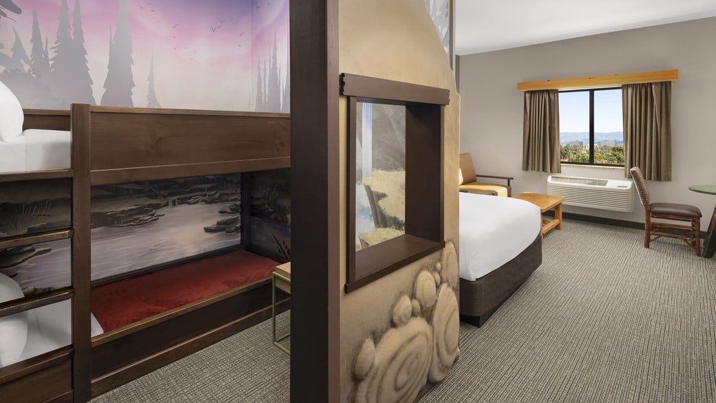 The room view with bunk beds and queen bed in Wolf Den Suite