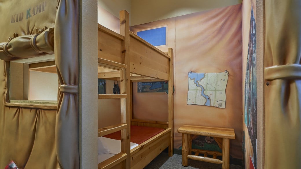 The bunk beds and TV inside the tent in the KidKamp Suite