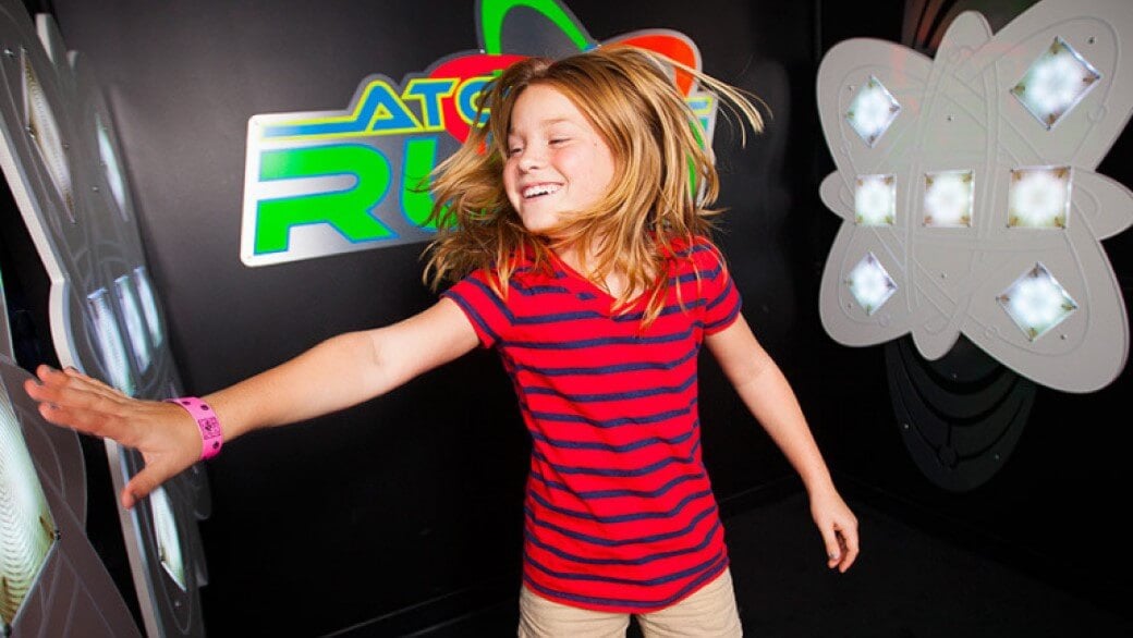 A girl presses light buttons at AtomicRUSH