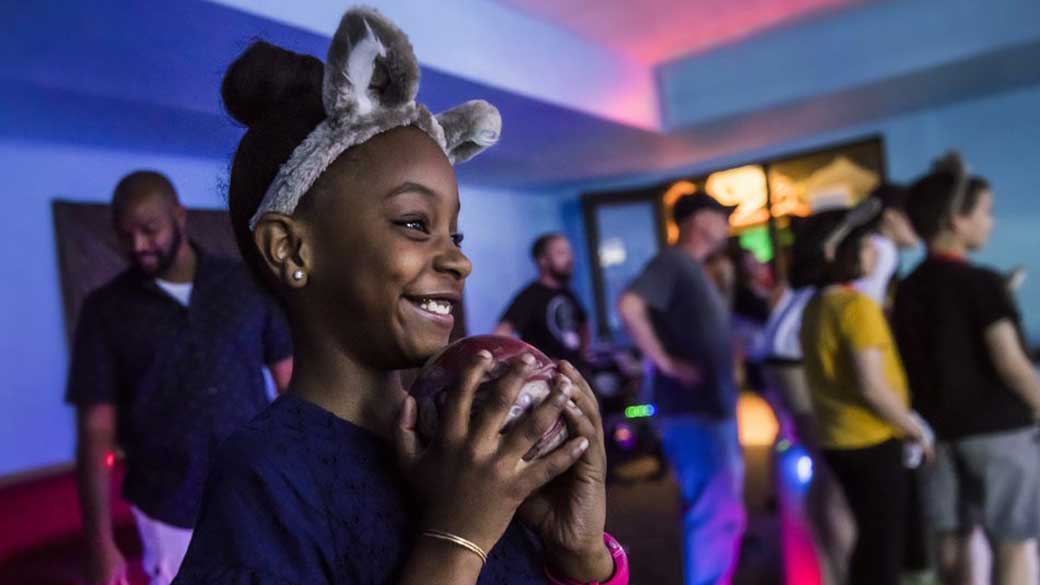 Girl with wolf ear holding a red bowling bowl