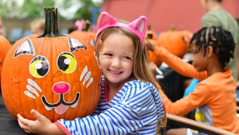 Girl smiling with her pumpkin art