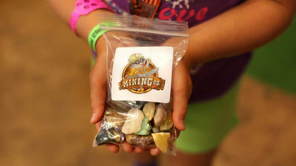 Kid holding a bag with gemstones 