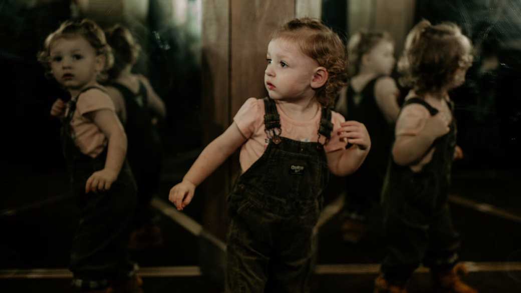 Small girl exploring the mirror maze