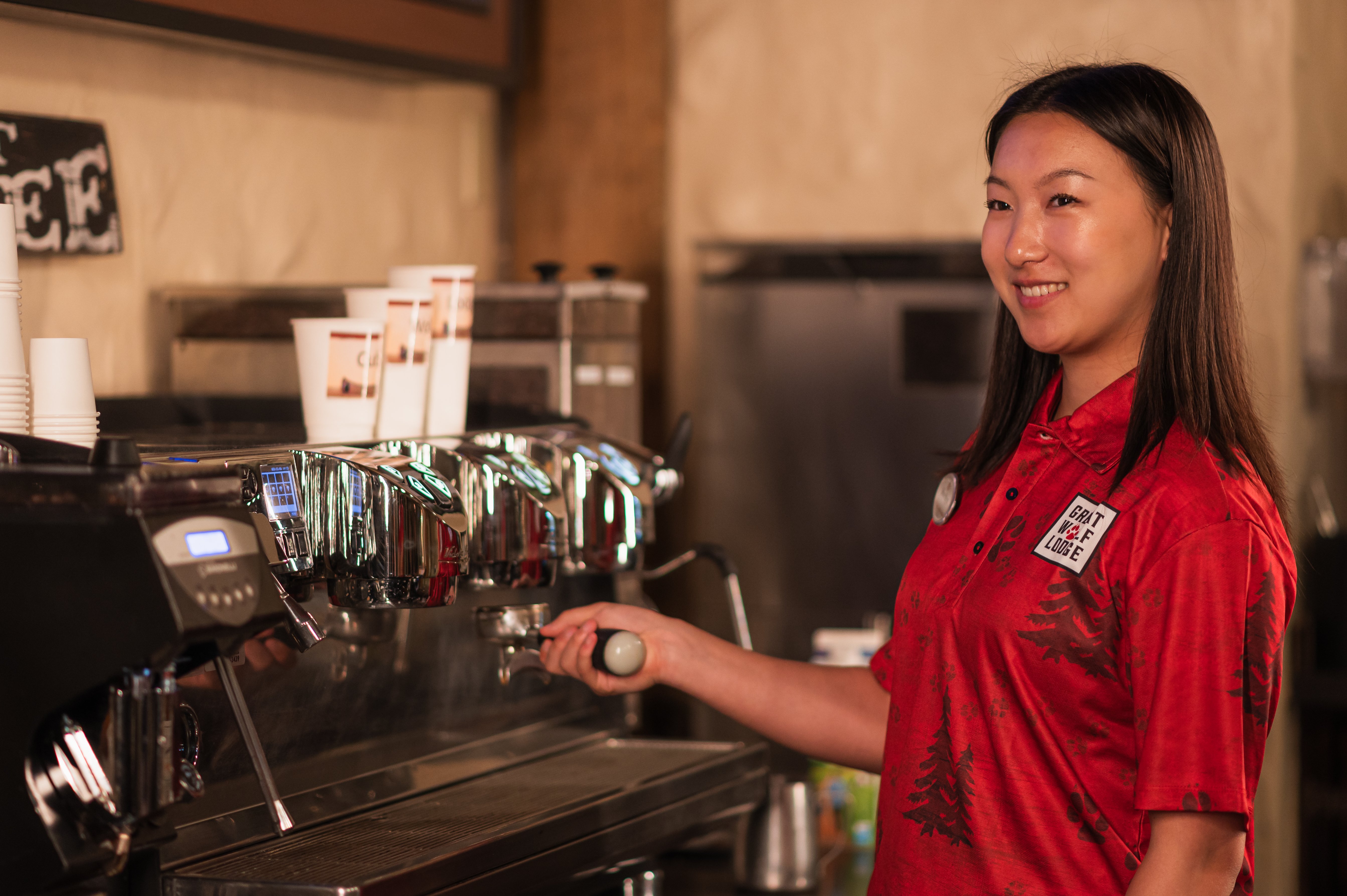 server filling in coffee in coffee machine