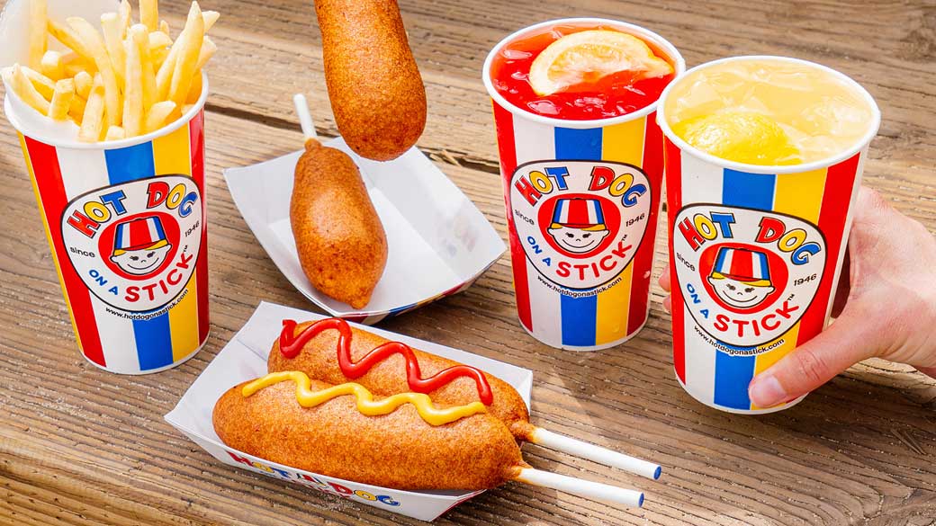 Hot dog on a stick and drinks