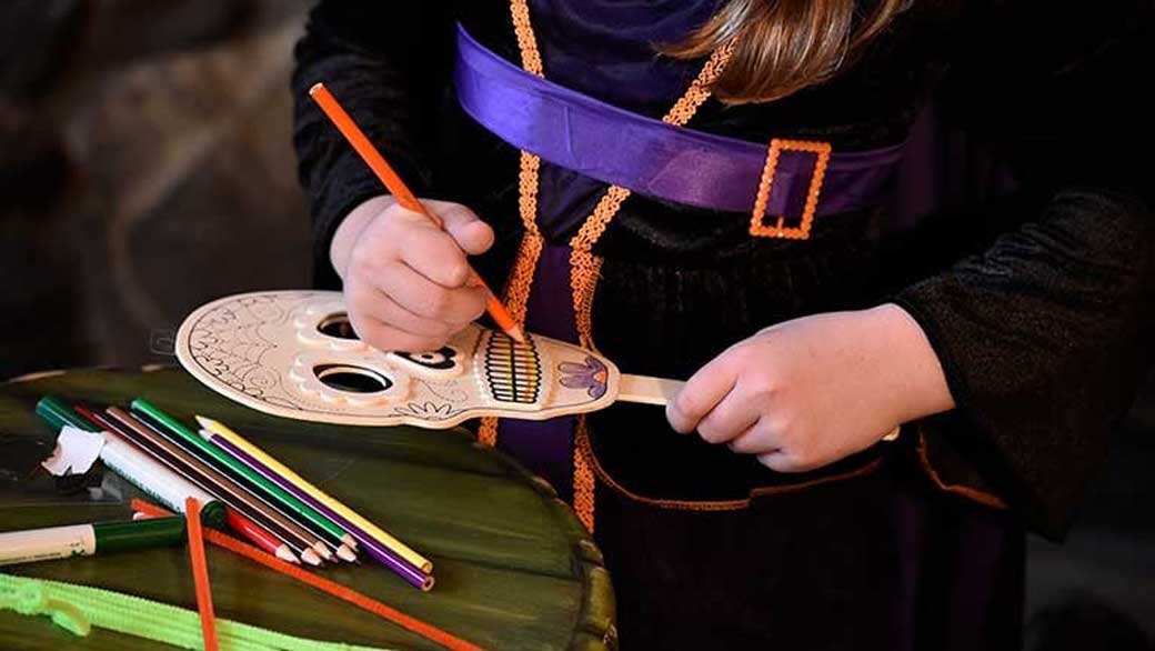 kid doing a Halloween crafts project 