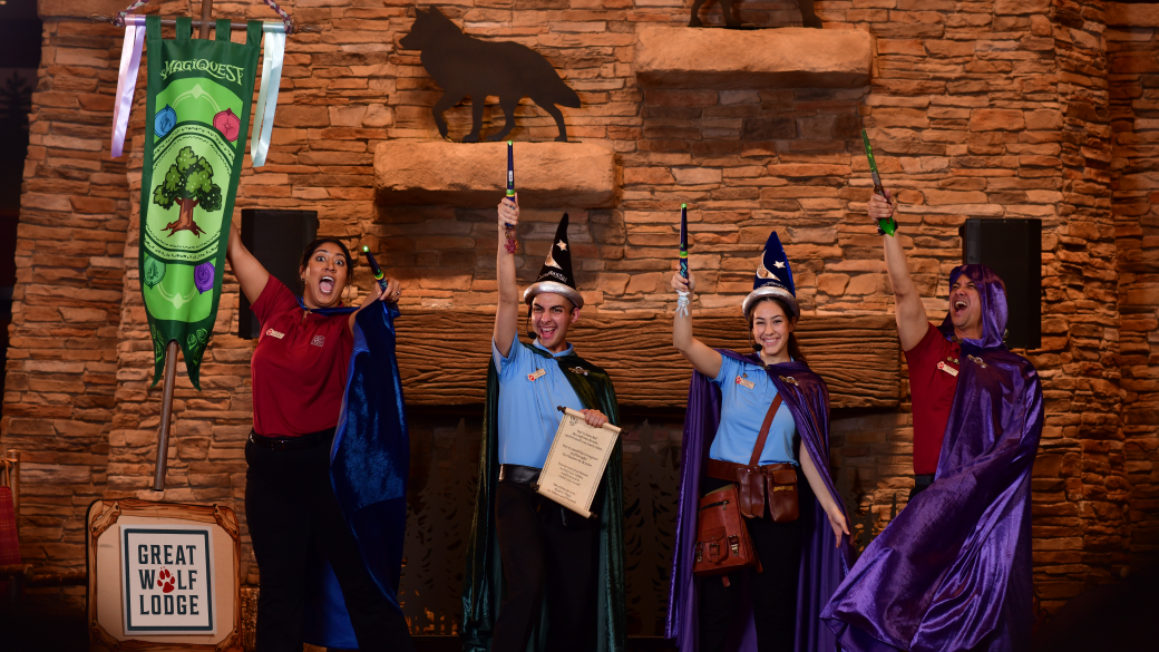 employees raise the wands in joy