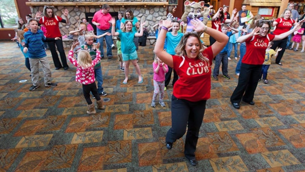 kids doing dance along with a lodge employee